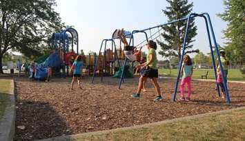 Kids play outside of the Forest Glade Community Centre in Windsor, September 1, 2015. (Photo by Mike Vlasveld)