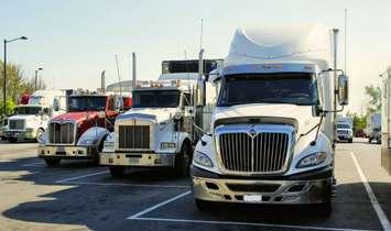 Transport trucks parked in a row. (Photo from Pxhere)