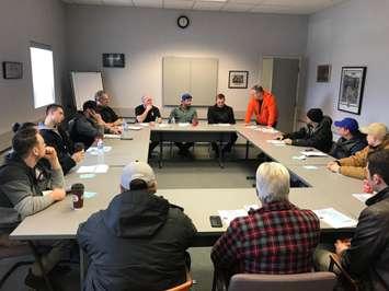 Employees at Sterling Fuels listen as Unifor Local 444 president James Stewart (in orange jacket) discusses their new contract deal. Photo courtesy of Unifor Local 444/Facebook.