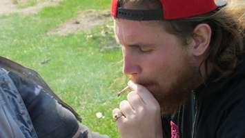 A man smokes a joint during 4/20 at London's Victoria Park, April 20, 2016. (Photo by Kirk Dickinson)