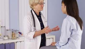 A doctor speaks with a patient. File photo courtesy of © Can Stock Photo / rocketclips