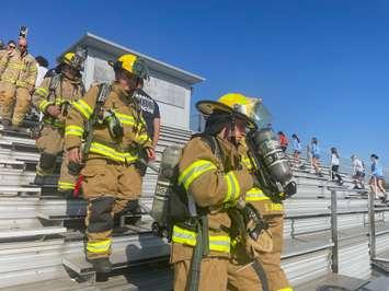 LaSalle fire fighters climb the bleachers and St. Thomas of Villanova High School to mark the anniversary of 9/11. 