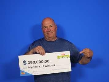 Michael Kennedy of Windsor shows off his $350,000 prize cheque at the OLG Prize Centre in Toronto, May 8, 2024. Photo provided by OLG.