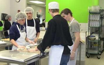 Students with the GECDSB prepare food for the grand opening of the Unemployed Help Centre community kitchen. 