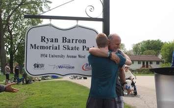 Terry Barron is hugged by a family member after a Windsor skate park is named in memory of his son Ryan, May 16, 2023. (Photo by Maureen Revait) 