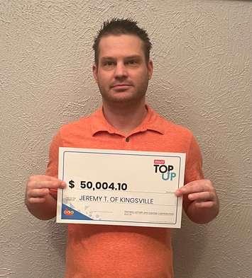 Jeremy Tiborcz of Kingsville displays his cheque for winning the Top Up feature. Photo provided by OLG.