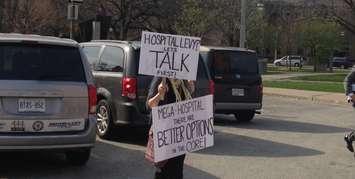 A protester outside Windsor City Hall in advance of April 18, 2016 council meeting. (Photo by Maureen Revait)