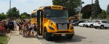 Students at St. Anne Catholic School in Belenheim get to ride the new electric school bus for the first time. June 15, 2018. (Photo by Greg Higgins)