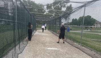 Windsor Mayor Drew Dilkens tests new batting cages at Wilson Park, July 9, 2024. (Photo by Maureen Revait) 
