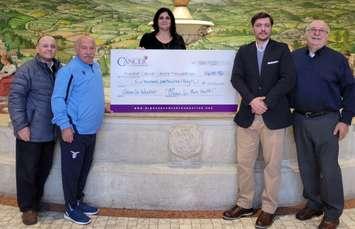 Presenting the 2021 Mangia for Men's Health cheque at the Ciociaro Club in Tecumseh are, from left, Rocco Muscedere, Joseph Capaldi, Cristina Conciatori, Massimo De Menech, and Armando Carlini, December 17, 2021. Photo provided by Mangia for Men's Health.