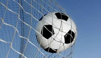 Soccer ball going into a net. © Can Stock Photo Inc. / mikdam