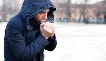 Man dressed in warm clothing in snowy weather (Image courtesy of Paolo Cordoni/Getty Images)