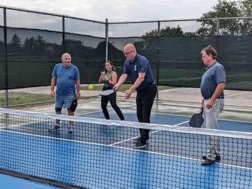 Windsor Mayor Drew Dilkens, centre, and Ward 8 Councillor Gary Kaschak, right, try out one of the new pickleball courts at Fontainebleau Park, Windsor, September 6, 2023. Photo by Mark Brown/WindsorNewsToday.ca.