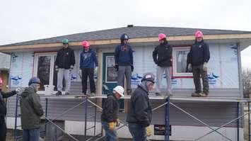 The Sarnia Sting helps with construction of Habitat for Humanity's latest build. December 2, 2014 (BlackburnNews.com photo by Jake Jeffrey)
