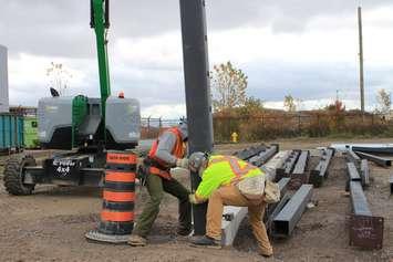 Ironworkers install the first of 228 steel structural columns in the ongoing construction of the new cutting-edge Stellantis North America Battery Technology Centre located at the Automotive Research and Development Centre (ARDC) in Windsor, Ontario. (Provided by Stellantis Canada) 