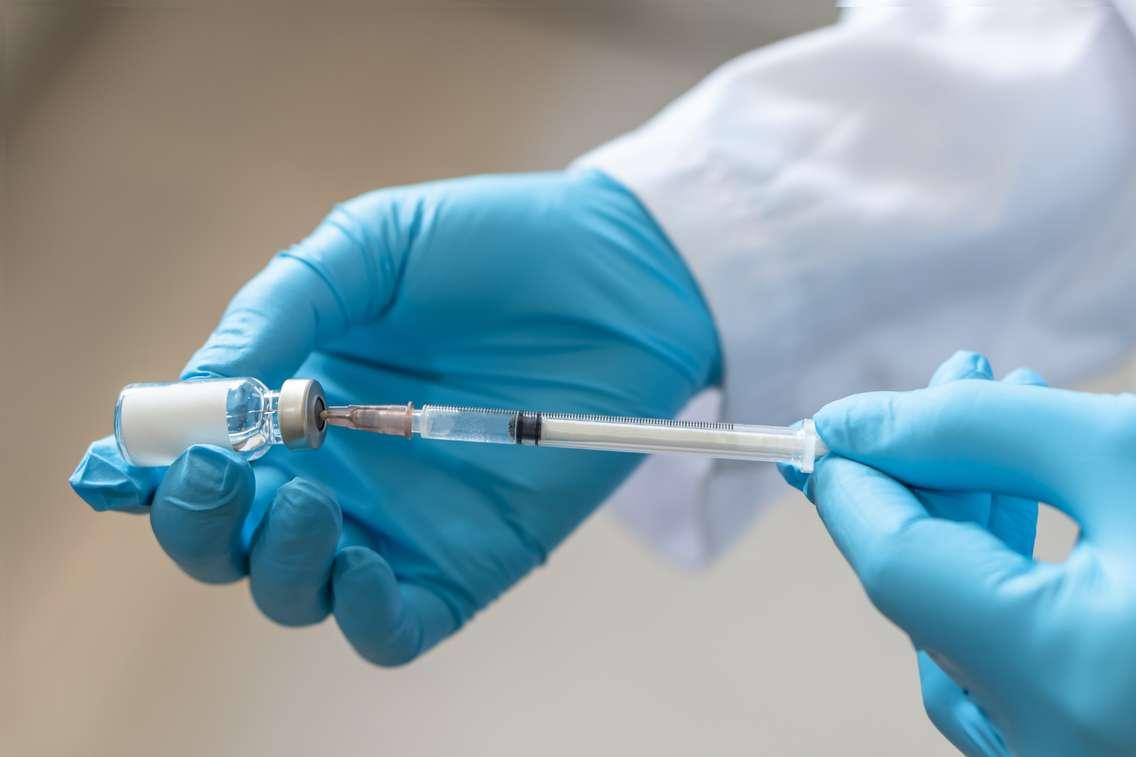 Preparing a needle for a vaccination. (Photo by Chinnapong/iStock / Getty Images Plus)