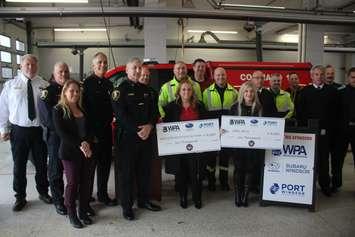 Cheques totaling $12,000 raised by the 2nd Annual Run With Responders 5K are presented at Windsor Fire Headquarters, November 20, 2024. Photo by Mark Brown/WindsorNewsToday.ca.