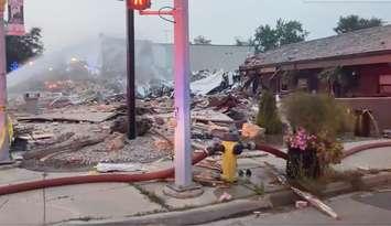 An explosion in downtown Wheatley on August 26, 2021 brings a building down to rubble  (Screengrab via Chatham-Kent Fire Twitter)