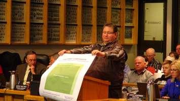 Rondeau Cottagers Association Vice President Brian French holds up a diagram about the Rondeau cottages' impact on the park (Photo taken by Jake Kislinsky).