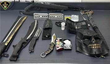 Assorted weapons and suspected illicit drugs seized in a traffic stop near Huntsville are shown on March 29, 2024. Photo courtesy OPP Almaguin Highlands.