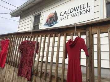 Red dresses hang outside the Caldwell First Nation office in Leamington on May 20, 2015. (Photo by Ricardo Veneza)