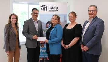 (Photo of ENWIN Utilities representatives presenting Habitat for Humanity staff with a cheque, courtesy of ENWIN)