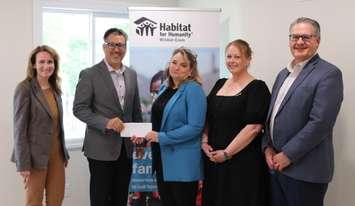(Photo of ENWIN Utilities representatives presenting Habitat for Humanity staff with a cheque, courtesy of ENWIN)
