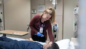  LHSC Registered Practical Nurse, Jessica, prepares an intravenous line to safely deliver fluids—one of many essential skills being refined through hands-on, in-unit training made possible thanks to the support of the RBC Foundation 