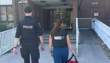 A Windsor police officer and a member of the Nurse Police Team approach Wheelton Manor on Glengarry Avenue in Windsor, August 2024. Photo courtesy Windsor Police Service/X