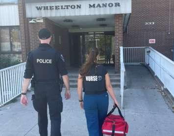 A Windsor police officer and a member of the Nurse Police Team approach Wheelton Manor on Glengarry Avenue in Windsor, August 2024. Photo courtesy Windsor Police Service/X