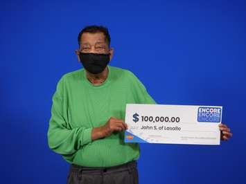 John Stark of LaSalle shows off his $100,000 cheque at the OLG Prize Centre in Toronto. Photo submitted Ontario Lottery and Gaming.