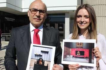 Lawyer John Nunziata and Dog Tales representative Clare Forndran hold photos of the rooms at the shelter outside Chatham Superior Court on March 18, 2016. (Photo by Ricardo Veneza)