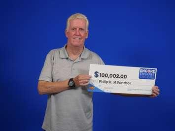 Philip Knuckle of Windsor shows off his $100,000 prize cheque at the OLG Prize Centre in Toronto, August 29, 2023. Photo provided by Ontario Lottery and Gaming.