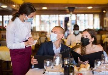 A server takes an order inside of a restaurant. File photo courtesy of © Can Stock Photo / JackF