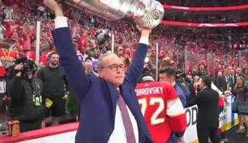 Overcome with emotion, Florida Panthers head coach Paul Maurice lifts the Stanley Cup following the Panthers' Game 7 win over the Edmonton Oilers in Sunrise, Florida, June 24, 2024. Screenshot courtesy NHL.com via ESPN.