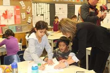 Students receive instruction on a math problem from their teacher at H.J. Lassaline, November 18, 2015. (Photo by Maureen Revait) 