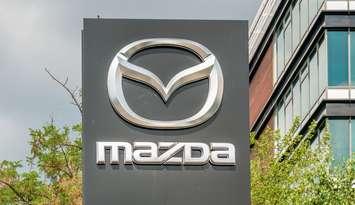 Mazda at the entrance of a car dealership (Image by Cristi Croitoru / iStock Editorial / Getty Images Plus)