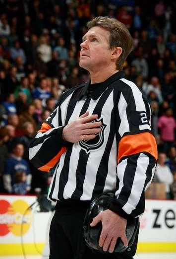 Former NHL referee Kerry Fraser stands for the national anthem prior to the a game. (Photo courtesy of Kerry Fraser)