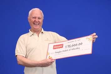 Wheatley resident Douglas Malott shows off his lottery winnings. (Photo courtesy of OLG)