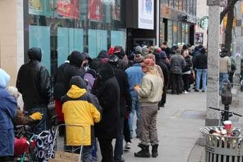 People in need line up along Ouellette Ave. in Windsor in hopes of receiving one of 500 turkeys being given away, December 17, 2014. (photo by Mike Vlasveld)