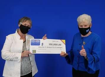Mary Ann Sherman of Leamington and Donna Urbantke of London show off their $100,000 cheque at the OLG Prize Centre in Toronto, October 20, 2021. Photo provided by OLG.