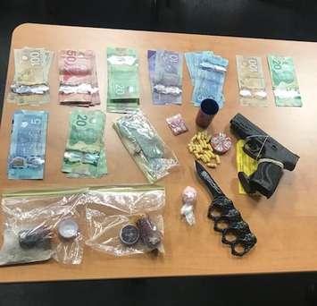 Seized drugs, weapons, and Canadian cash from a home on Stewart Street in Kingsville are displayed on November 2, 2020. Photo provided by Ontario Provincial Police.
