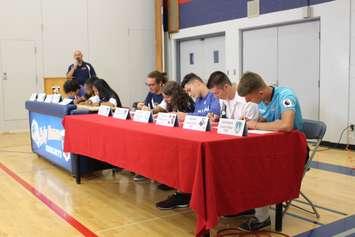 Holy Names Catholic High School students sign post-secondary athletic scholarships, June 20, 2017. (Photo by Mike Vlasveld)