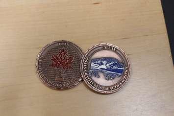 The "All in Coin" given to first responders to help start the conversation mental wellness.  (photo by Maureen Revait)