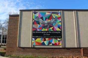 Students at Westview Freedom Academy in Windsor hang a mural on the outside of their school, November 29, 2016. (Photo by Mike Vlasveld)