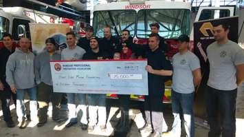 Firefighters at Windsor Fire and Rescue Station #5 present a $15,000 check to the Fight Like Mason Foundation on January 19, 2018. Photo by Mark Brown/Blackburn News.