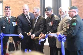 From left, Lieutenant Colonel John Hodgins of the Essex and Kent Scottish, Windsor Mayor Drew Dilkens and University of Windsor President Alan Wildeman, join Essex County Warden Tom Bain, second right, in cutting the ribbon at the opening of the U of W School of Creative Arts, March 22, 2018. Photo by Mark Brown/Blackburn News.