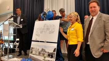 Hospice of Windsor and Essex County board chairperson Veronique Mandal helps reveal plans for the expansion of Hospice's Windsor residential complex during its tenth anniversary celebration on May 17, 2017.  (Photo by Mark Brown/Blackburn News)