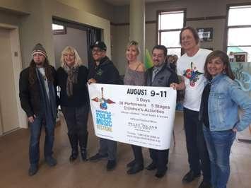 Kingsville Folk Festival co-producer Michele Law, centre, Mayor Nelson Santos, third from right, and co-producer John Law, second from right, pose with festival board members at Carnegie Arts in Kingsville, April 11, 2019. Photo by Mark Brown/Blackburn News.