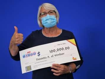 Dusanka Andjelkovic of Windsor collects her $100,000 cheque at the OLG Prize Centre in Toronto, July 15, 2020. Photo provided by OLG.
